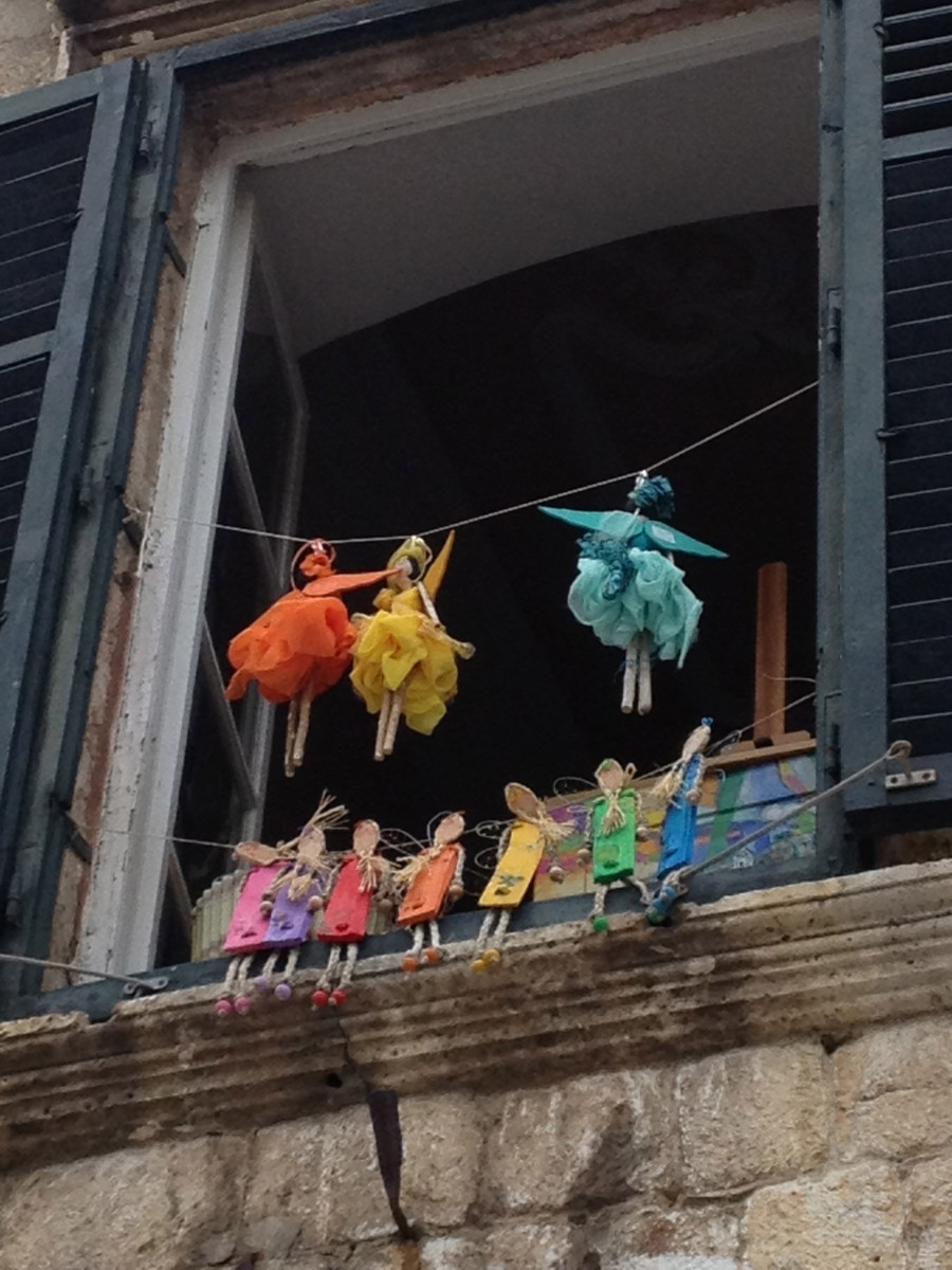 handmade colorful fairies in a window