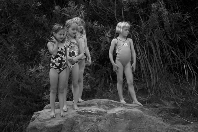 girls standing on a rock