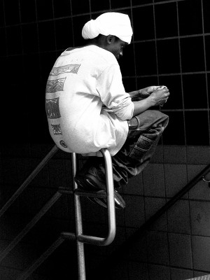 woman sitting on a stool in black and white
