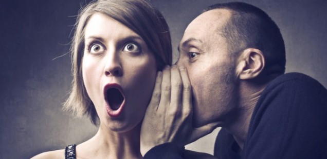two people whispering