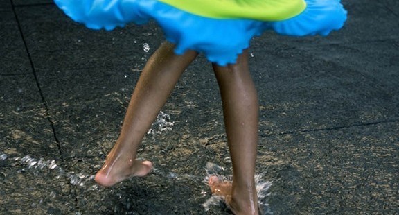 young girl splashing in the water