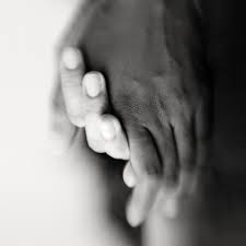 two hands holding each other